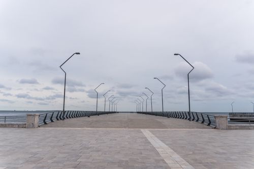 Free A tranquil view of an empty promenade with street lamps by the Caspian Sea in Baku. Stock Photo