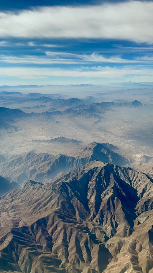 Free Stunning aerial view of Kabul's rugged mountain landscape under a clear blue sky. Stock Photo