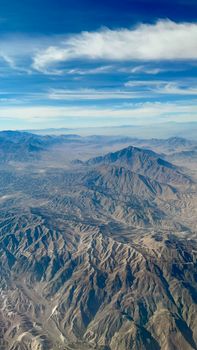 Stunning aerial view of Kabul's mountainous terrain under a clear blue sky.