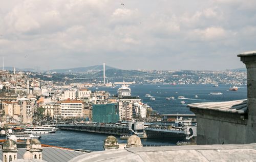 Free Aerial view of Istanbul with Bosphorus Bridge and bustling harbor under cloudy skies. Stock Photo
