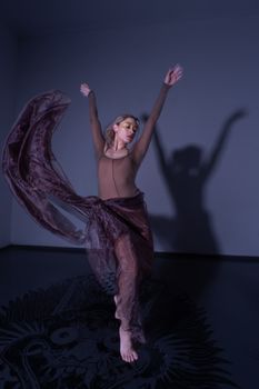Artistic dance performance captured with graceful movement in flowing attire, creating dynamic motion.