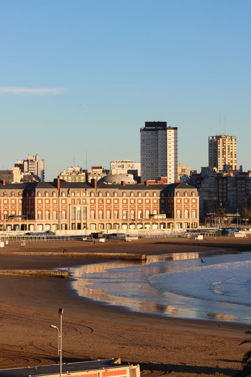 Free Sunlit beachfront of Mar del Plata, Argentina, showcasing historic architecture and golden sands. Stock Photo
