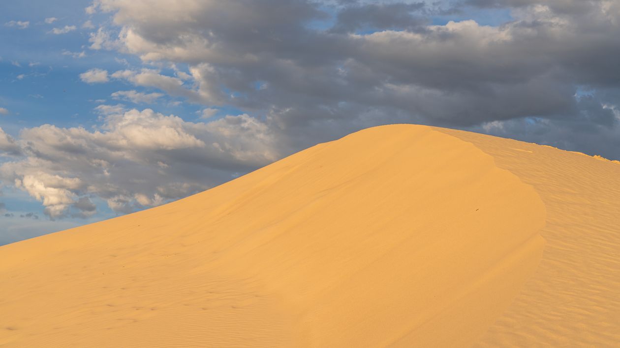 Golden Sand Dunes Under a Vibrant Sky · Free Stock Photo