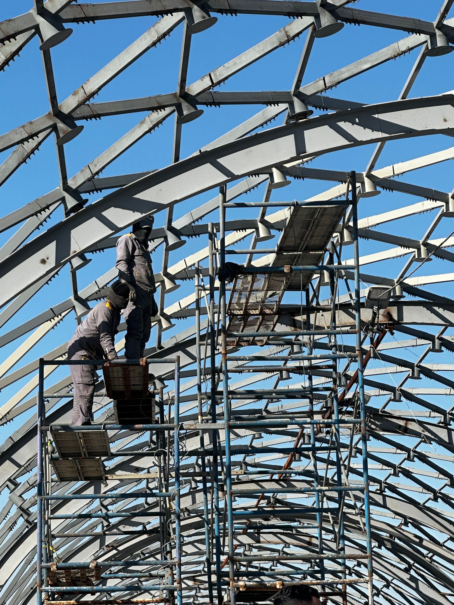 Construction workers on scaffolding at a job site
