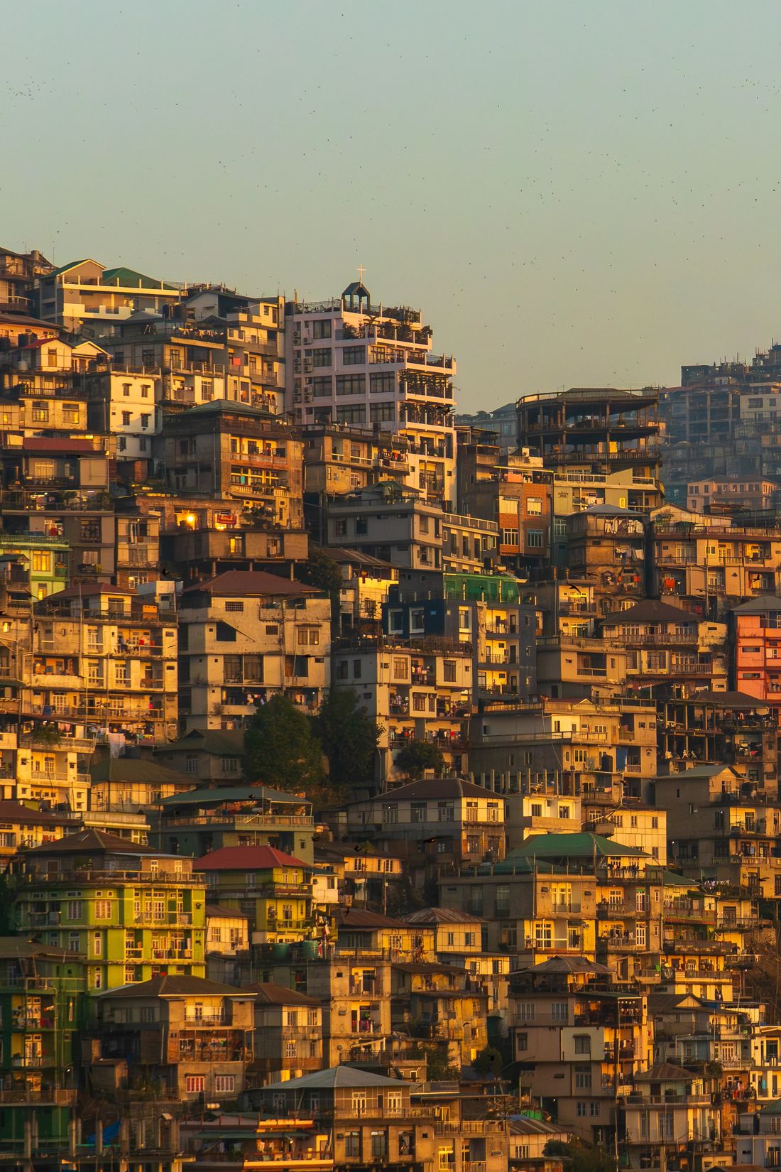Aizawl hillside homes glowing in warm evening light