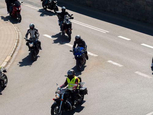 Free Aerial view of motorcyclists riding through a street in Wrocław, Poland on a sunny day. Stock Photo