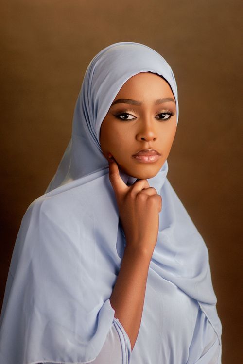 Free Portrait of a young woman wearing a blue hijab, exuding elegance and grace. Stock Photo