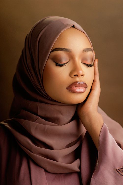 Free Portrait of a woman in a hijab with closed eyes, exuding elegance and calm. Stock Photo
