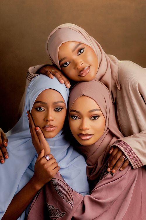 Free Elegant portrait of three women wearing hijabs, exuding grace and unity. Stock Photo