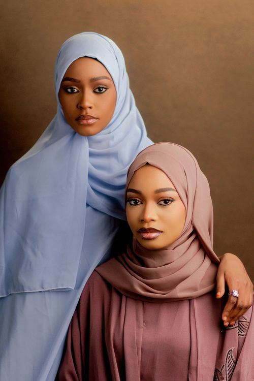 Free A captivating portrait of two women wearing stylish hijabs, exuding elegance and grace. Stock Photo
