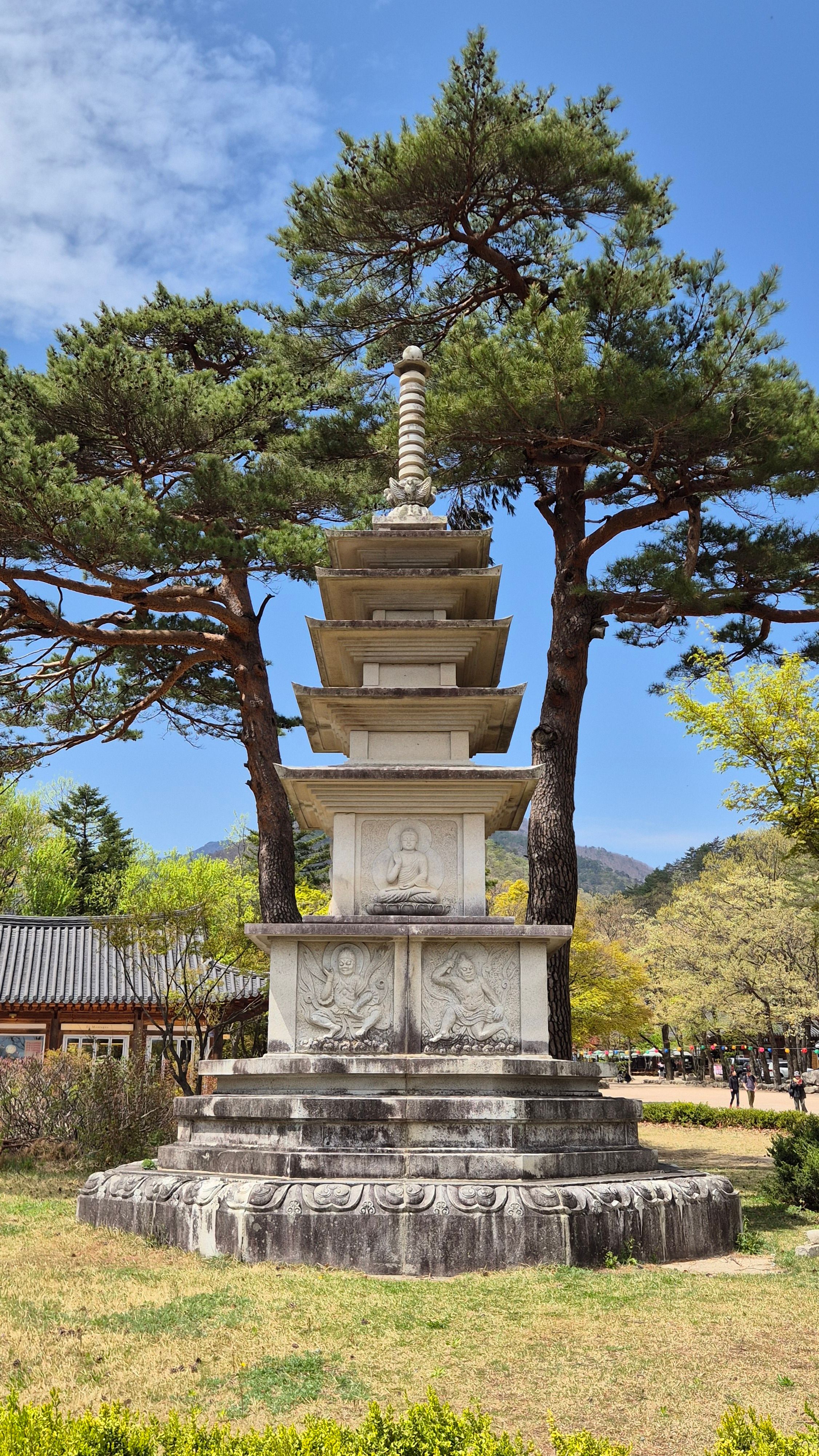 A captivating view of a traditional stone pagoda surrounded by trees in Samhwasa Temple, Korea.
