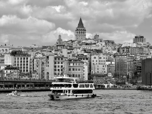 Free Black and white view of Istanbul's Galata Tower with boats on the Bosphorus. Stock Photo