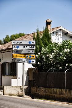 Street signs in Mallorca guide travelers to Alcudia and Palma.