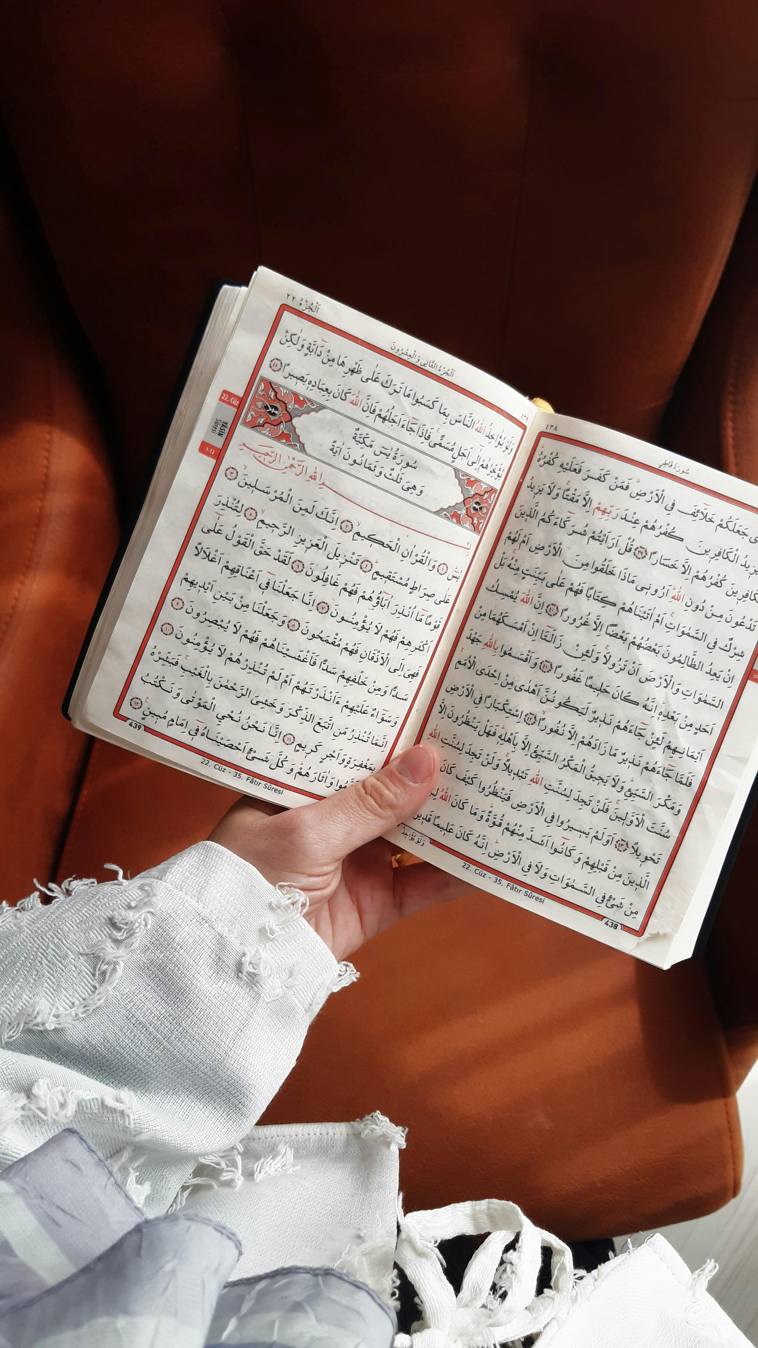 A person holding an open religious book, symbolizing spirituality and peaceful reflection.
