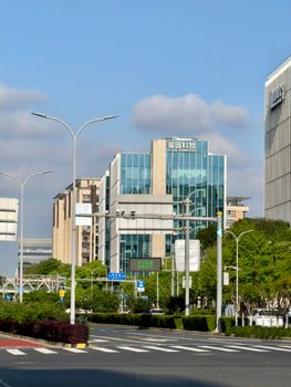 Sunny day view of contemporary office buildings on a street in Shanghai, China.
