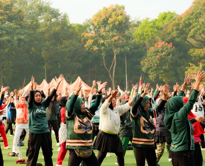 A busy fitness event with participants engaged in various activities, showcasing the energy of the atmosphere.
