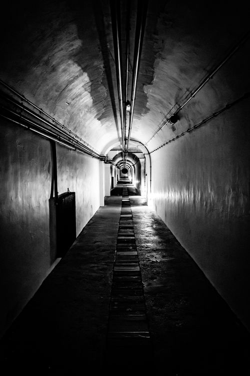 Free Explore a hauntingly dramatic black and white underground tunnel. Stock Photo