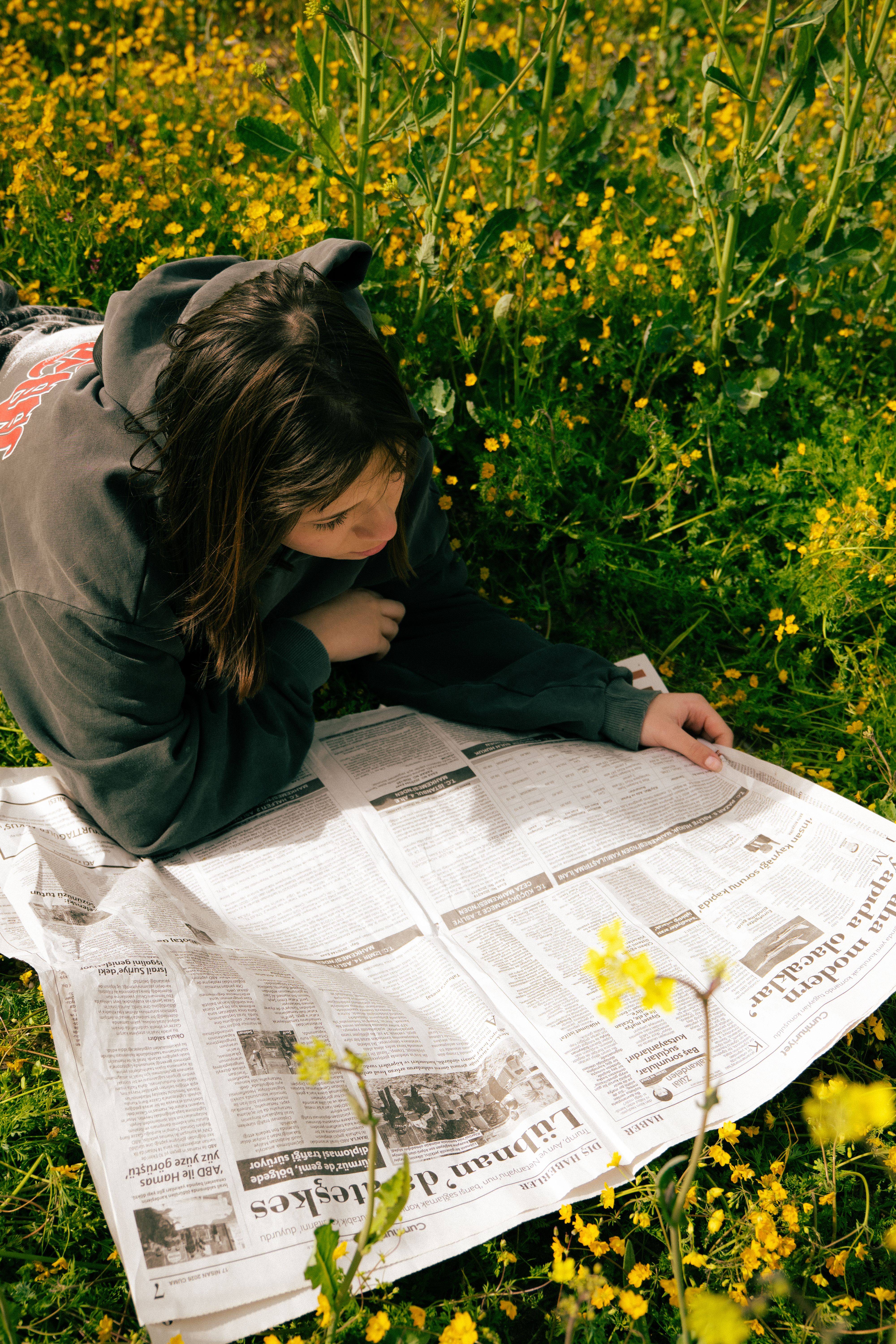 Woman Reading Newspaper in Spring Meadow · Free Stock Photo