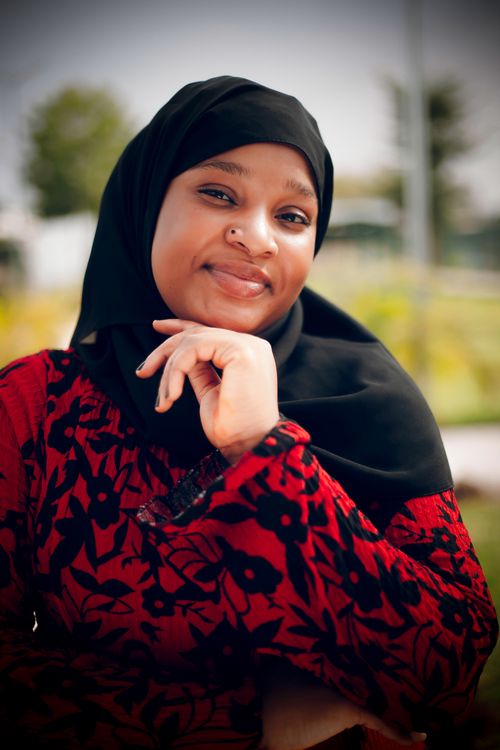 Young Woman in Hijab Smiling Outdoors · Free Stock Photo