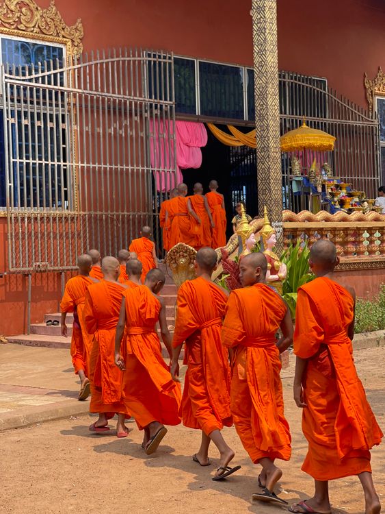 Monks in Orange Robes Entering Cambodian Temple · Free Stock Photo
