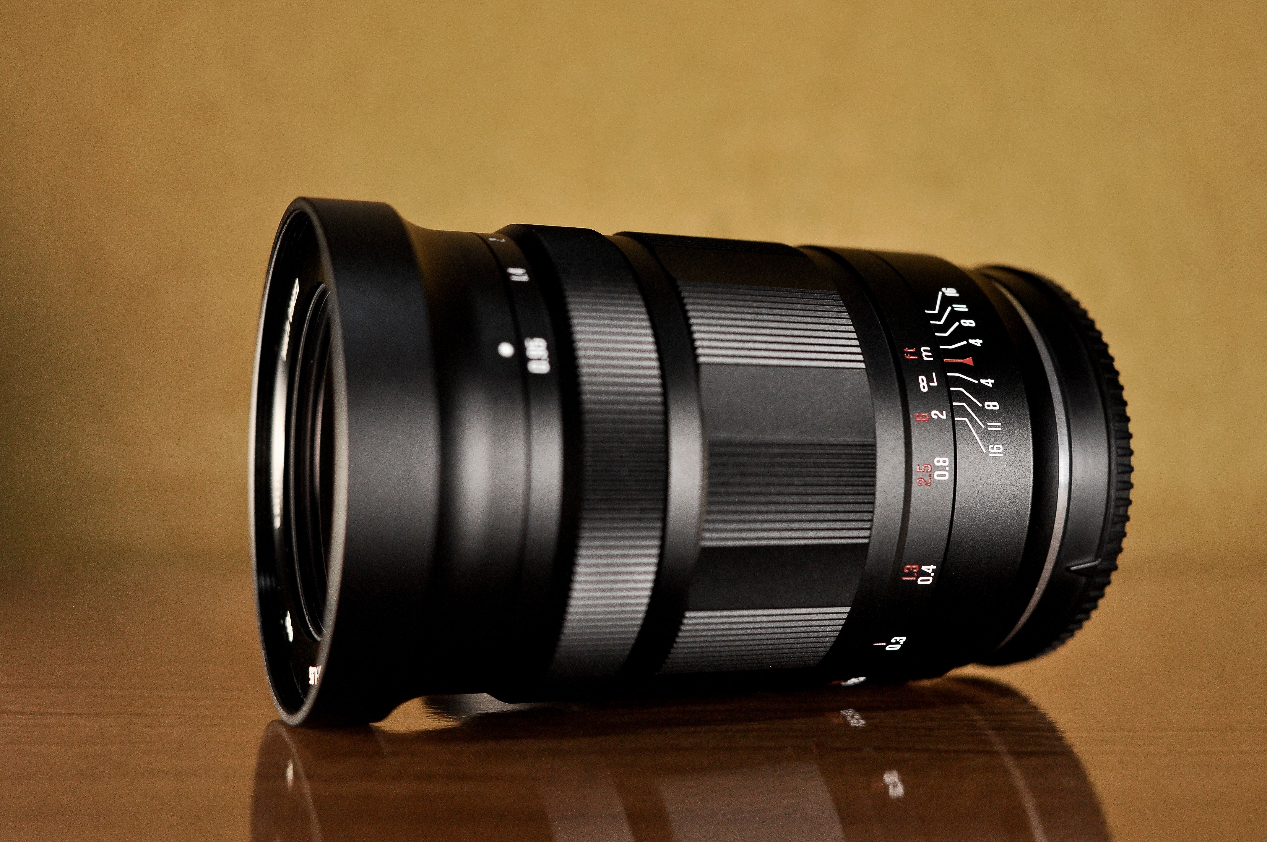 A detailed view of a camera lens showing focus and aperture settings, perfect for photography enthusiasts.