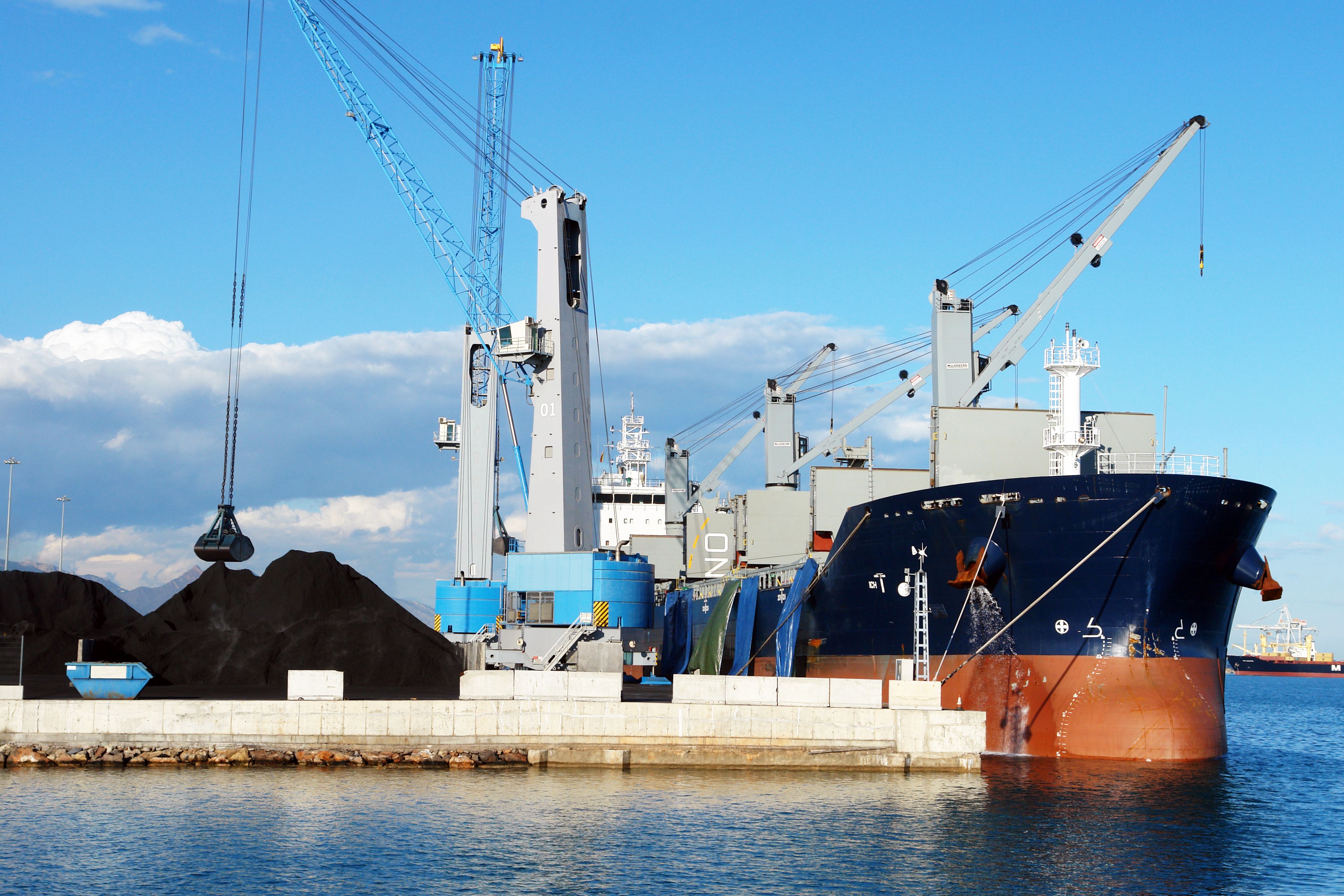Cargo Ship Docked at Industrial Port with Cranes · Free Stock Photo