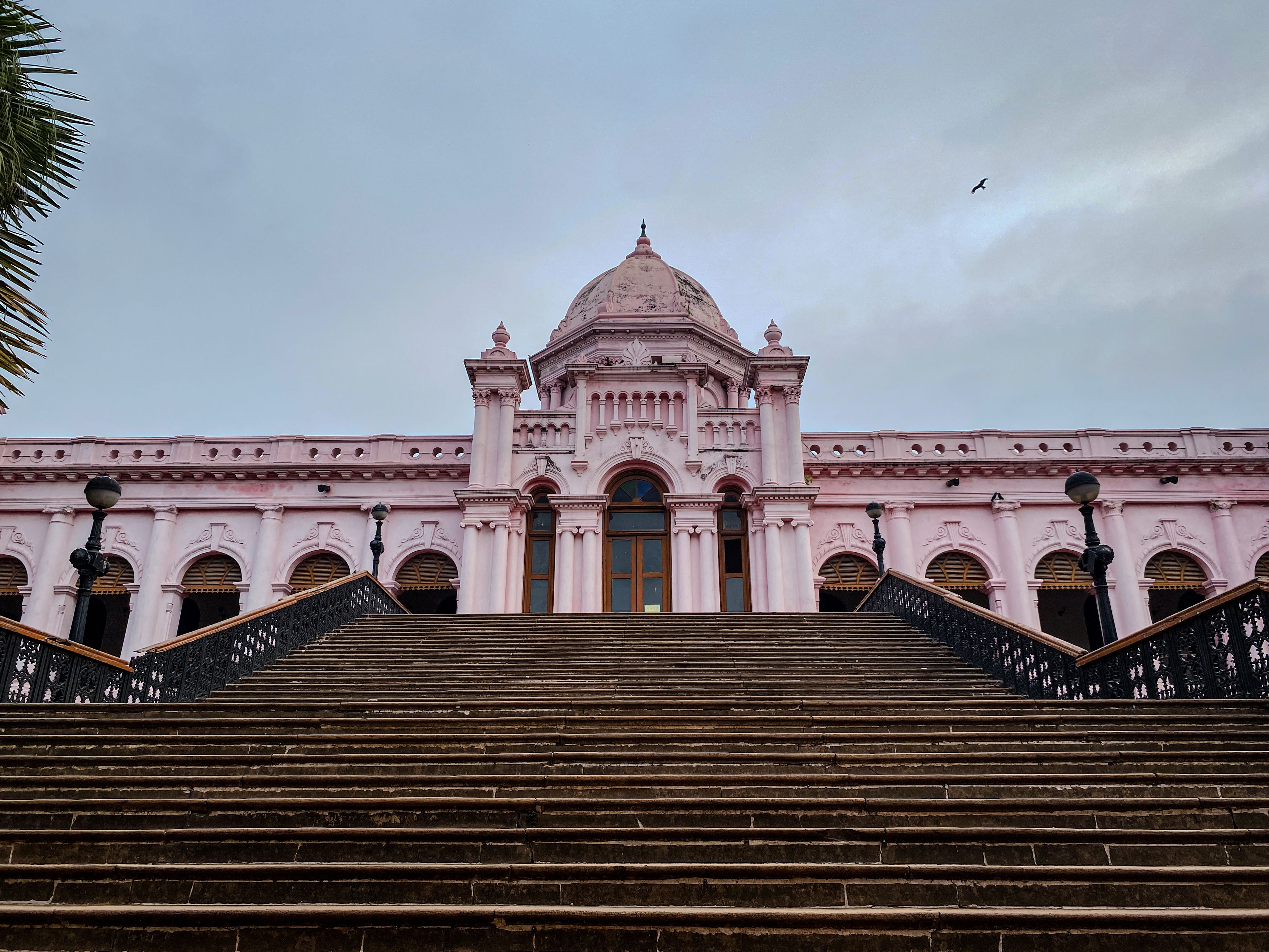 View of the iconic Ahsan Manzil with its grand staircase, a hallmark of Dhaka's rich history and architecture.