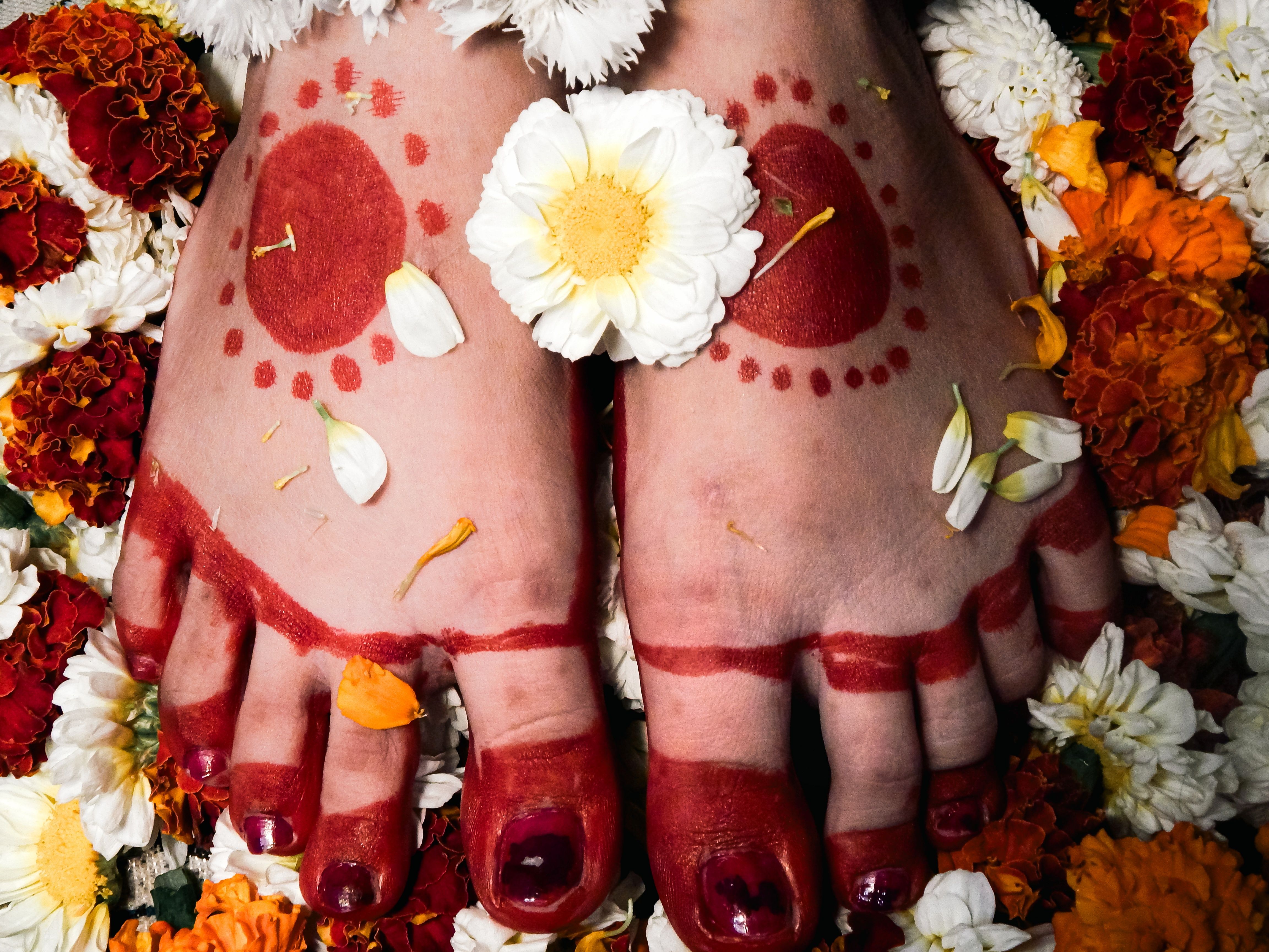 Beautifully adorned feet with henna and floral decorations symbolize cultural celebrations.