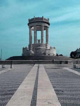 Historic War Memorial Monument in Ancona, Italy under a vibrant sky.