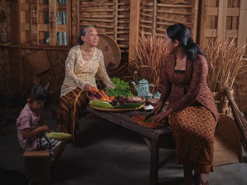 Free Three generations gather for traditional cooking in a rustic Javanese kitchen. Stock Photo