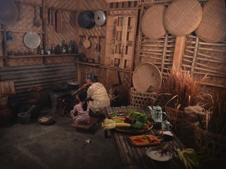 Authentic Indonesian village kitchen with a family cooking scene, highlighting traditional cooking methods.
