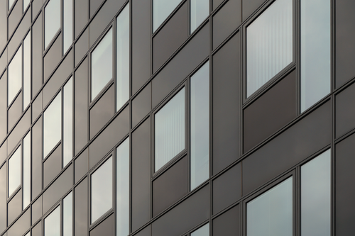 Free Modern building facade showcasing minimalist architecture with geometric window patterns. Stock Photo