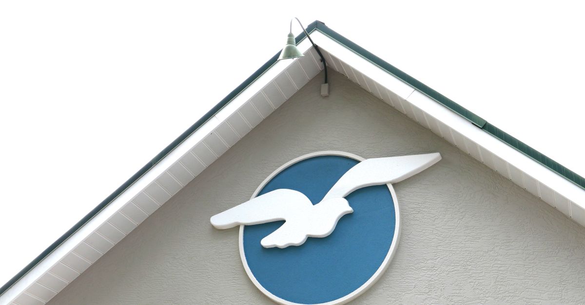 Close-up of a church facade in Lecanto, Florida with a modern dove symbol, symbolizing peace.