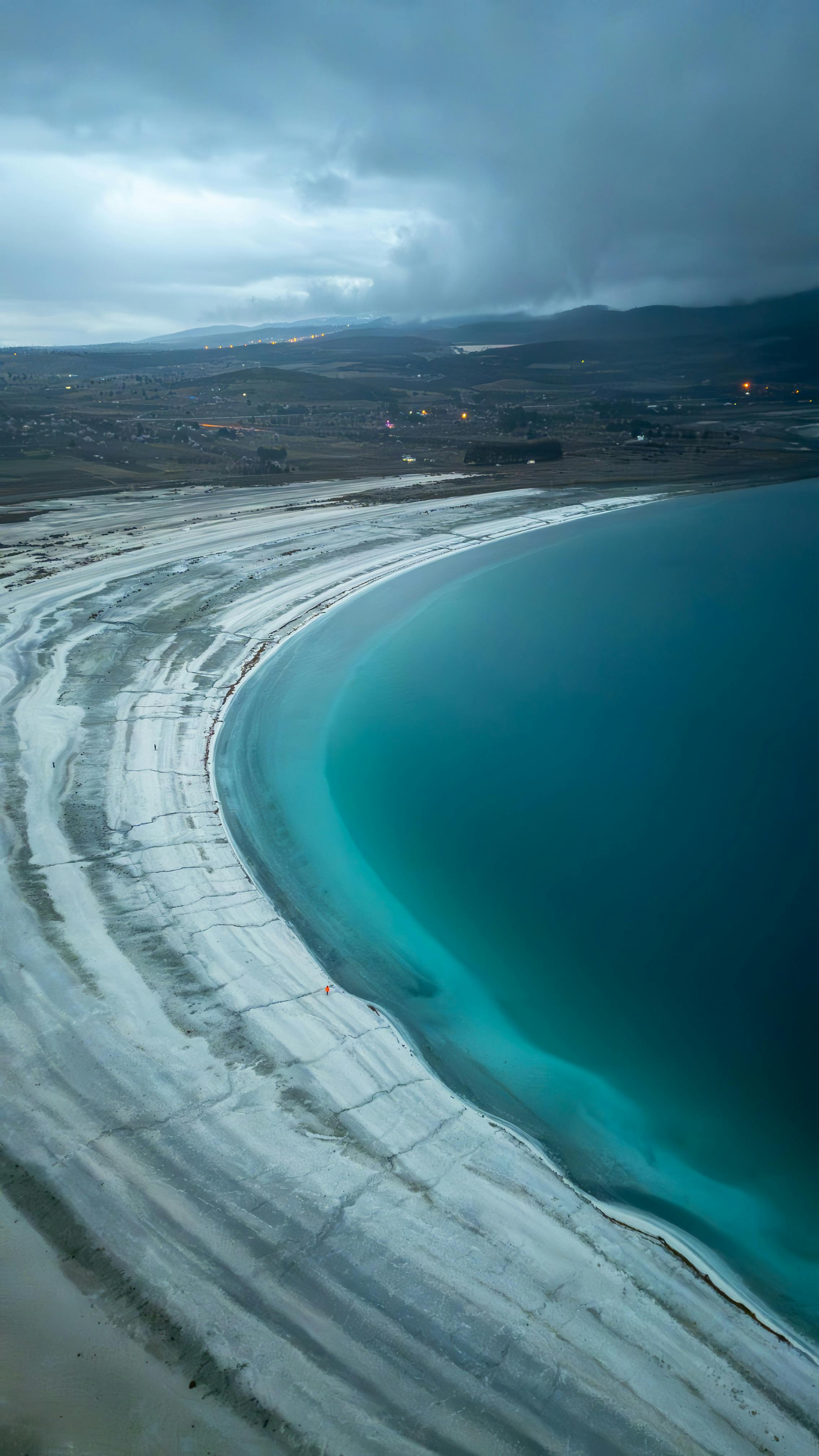 Discover the serene beauty of Salda Lake's turquoise waters and unique shoreline from above.