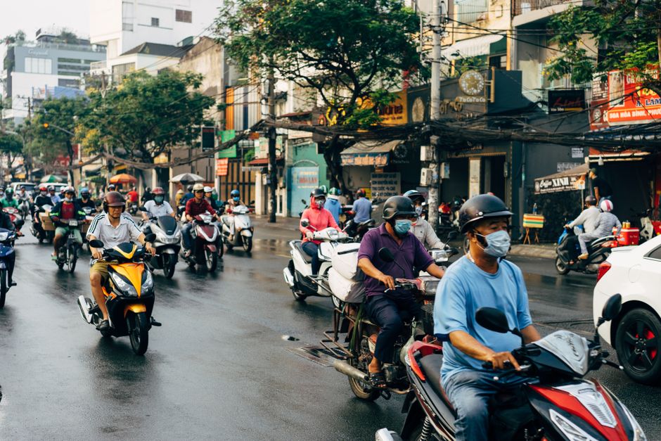 Vibrant scene of motorcyclists in Ho Chi Minh City, Vietnam, showcasing urban traffic flow.