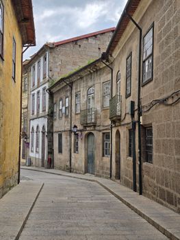 Charming old European street lined with historic stone buildings and classic architecture.