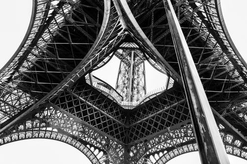 Free Black and white view from beneath the Eiffel Tower, showcasing intricate ironwork. Stock Photo