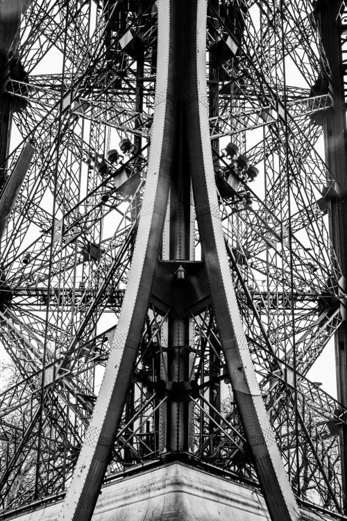 Free Detailed black and white view of the Eiffel Tower's iron framework in Paris, France. Stock Photo