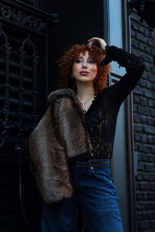 Elegant Woman Posing in Urban Setting · Free Stock Photo