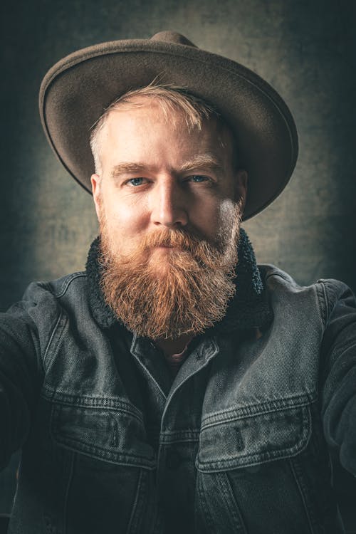 Man in Gray Denim Jacket Wearing Brown Cowboy Hat