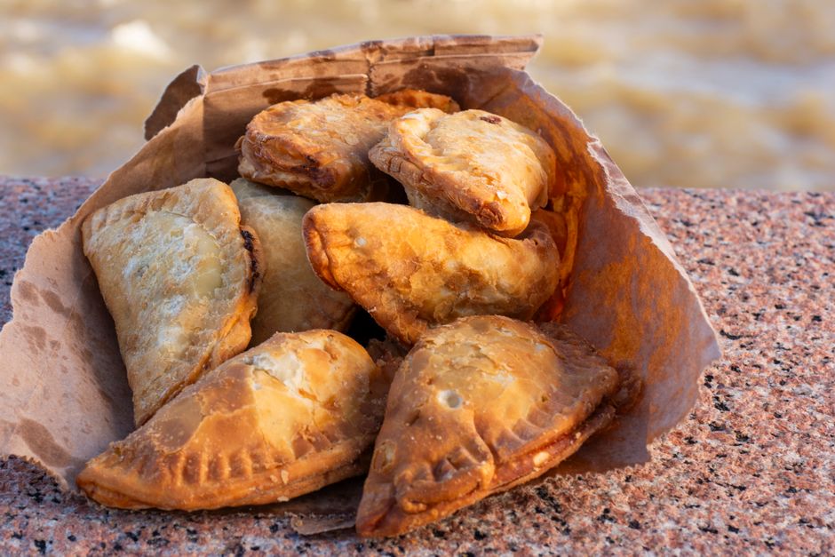 Freshly baked pastizzi, a traditional Maltese pastry with ricotta cheese or pea filling, displayed in Malta.