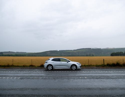 Silver Sedan Parked on Paved Pathway