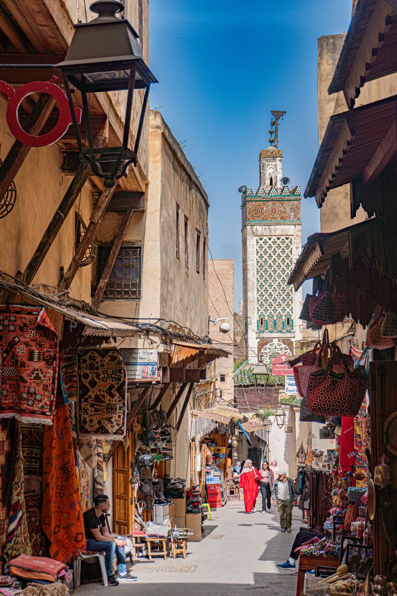 Fes medina street scene minaret Morocco
