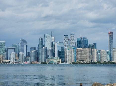Stunning view of Toronto's skyline with modern skyscrapers reflecting on Lake Ontario.