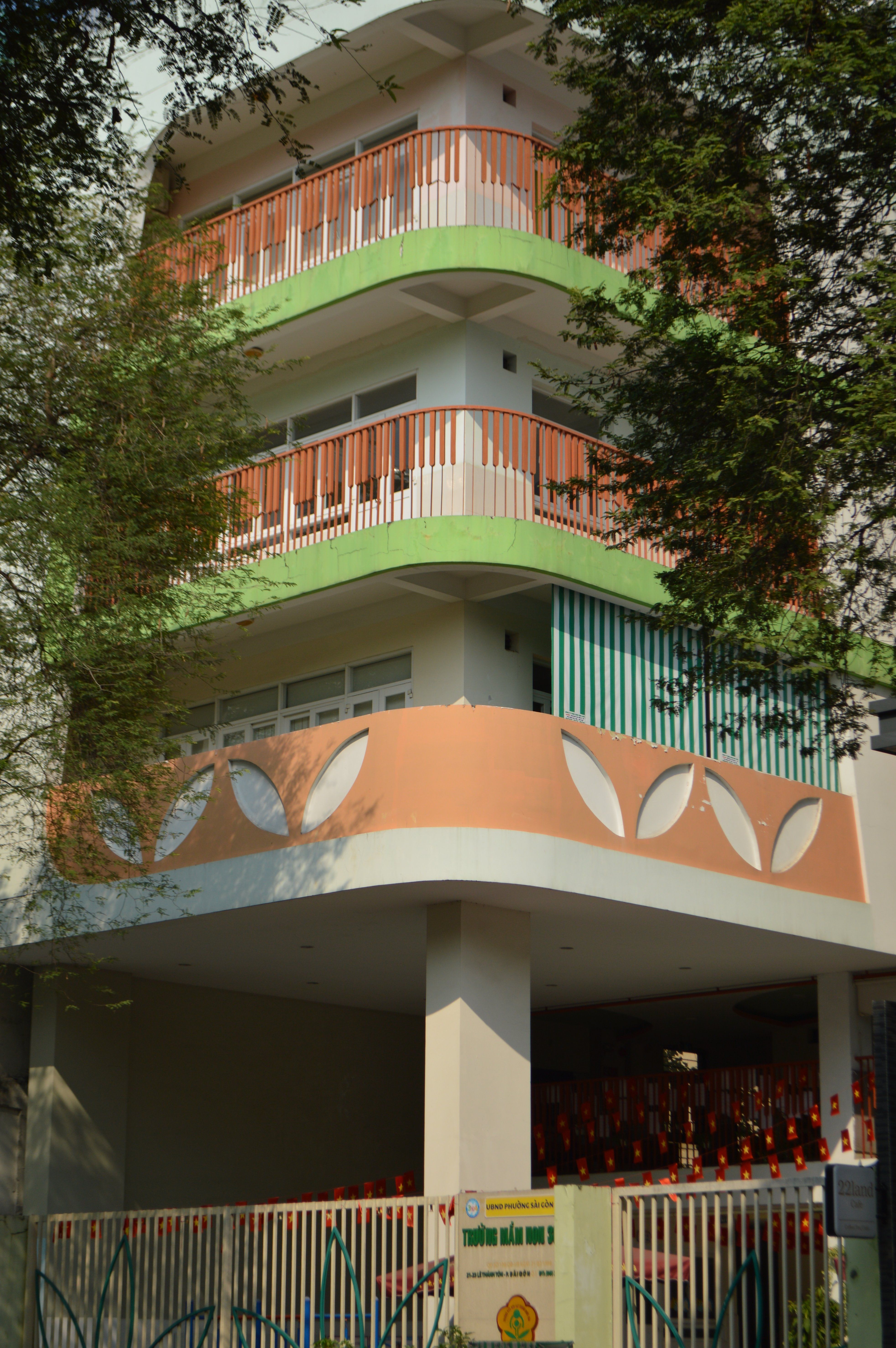Four-story building with colorful balconies and decorative elements