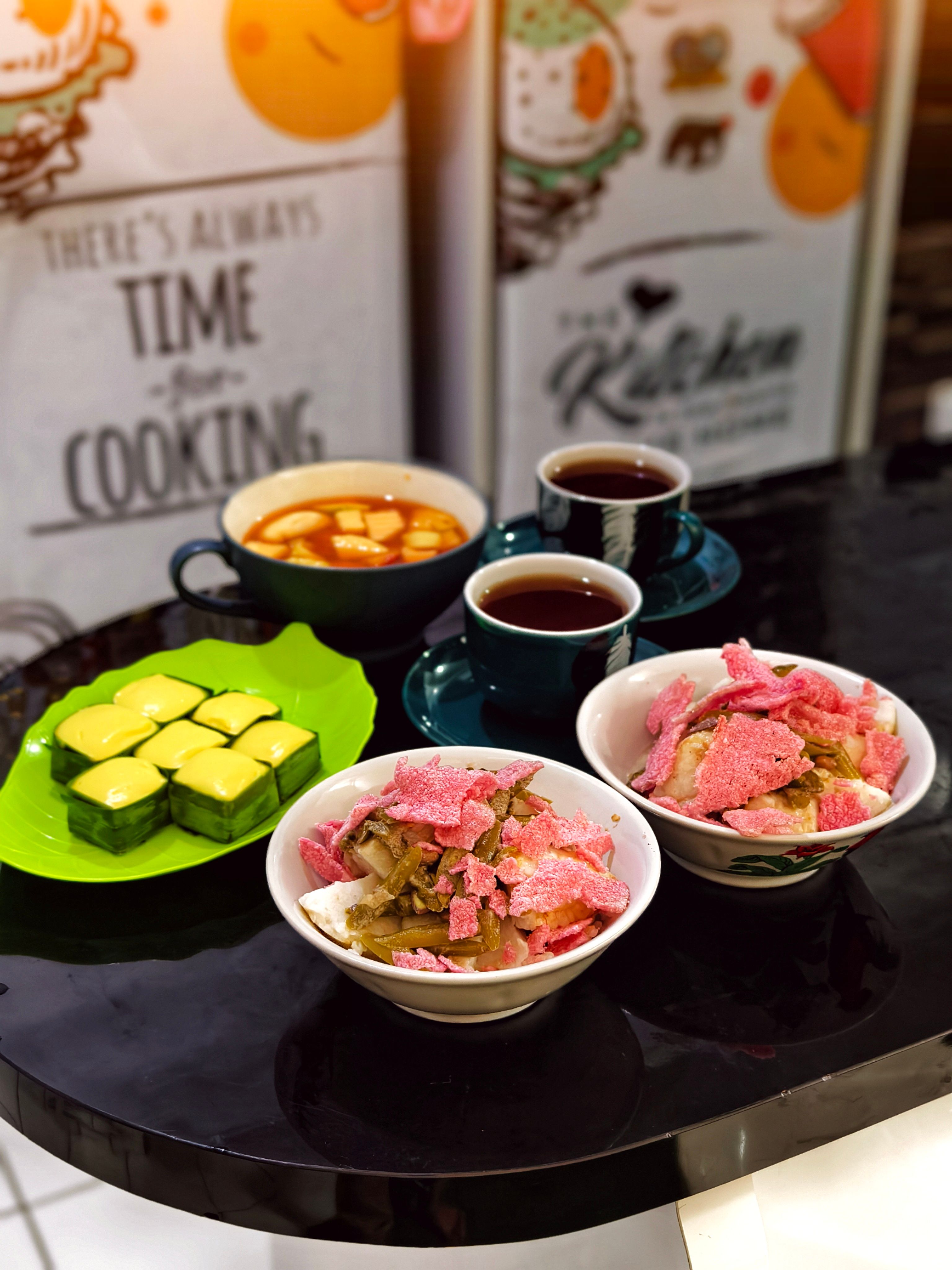 A delightful assortment of traditional Indonesian snacks served with tea, perfect for a cozy gathering.
