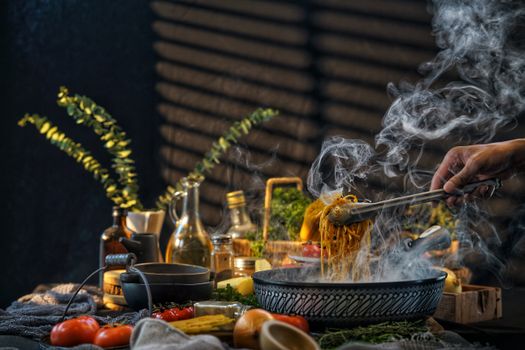 A steaming bowl of pasta being served in a well-lit rustic kitchen setting with fresh ingredients and utensils.