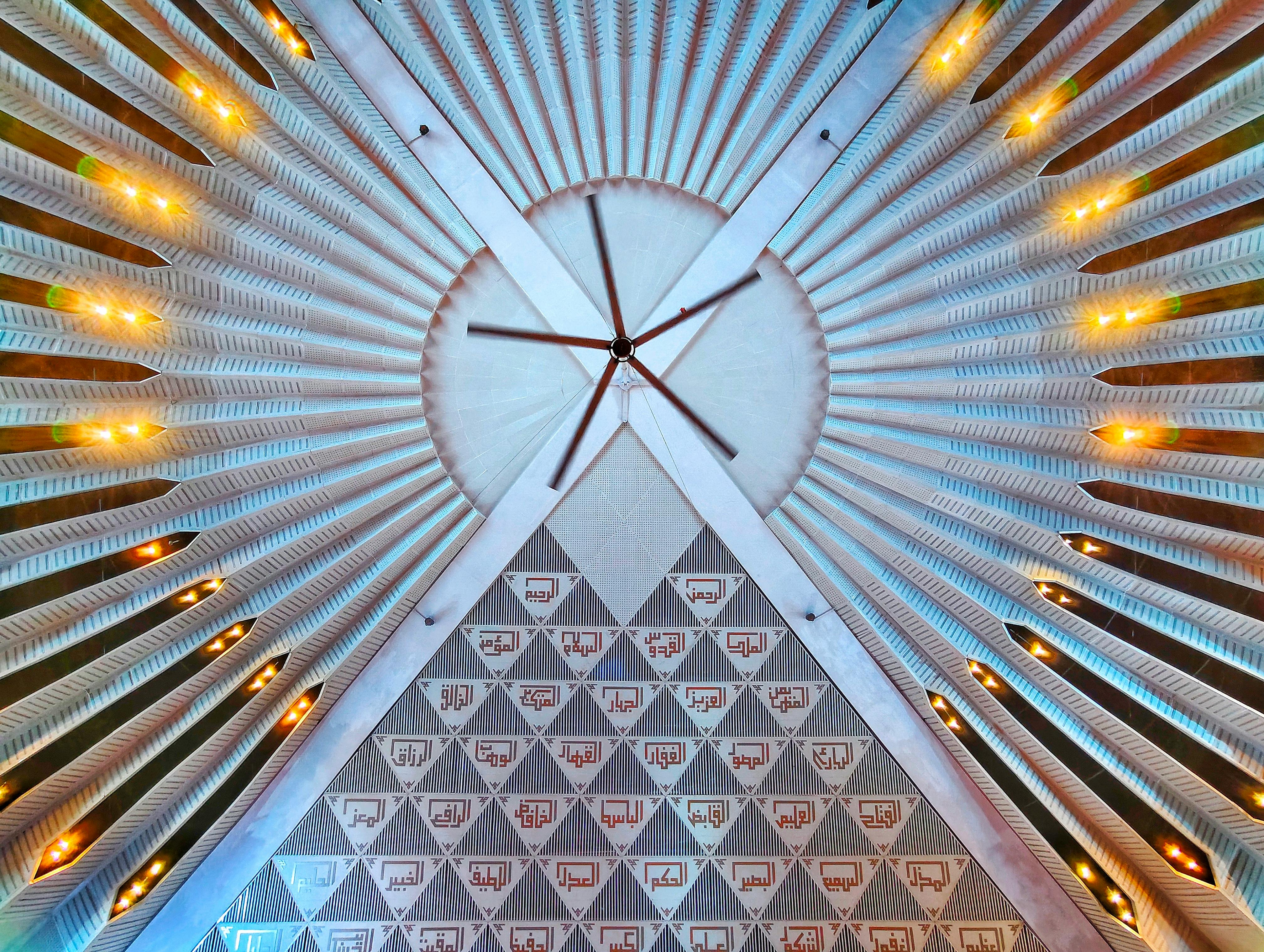 Detailed view of an ornate ceiling, showcasing geometric patterns and artistic lighting.