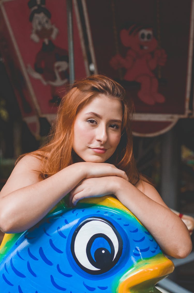 Content Woman With Big Fish Toy In Kids Studio