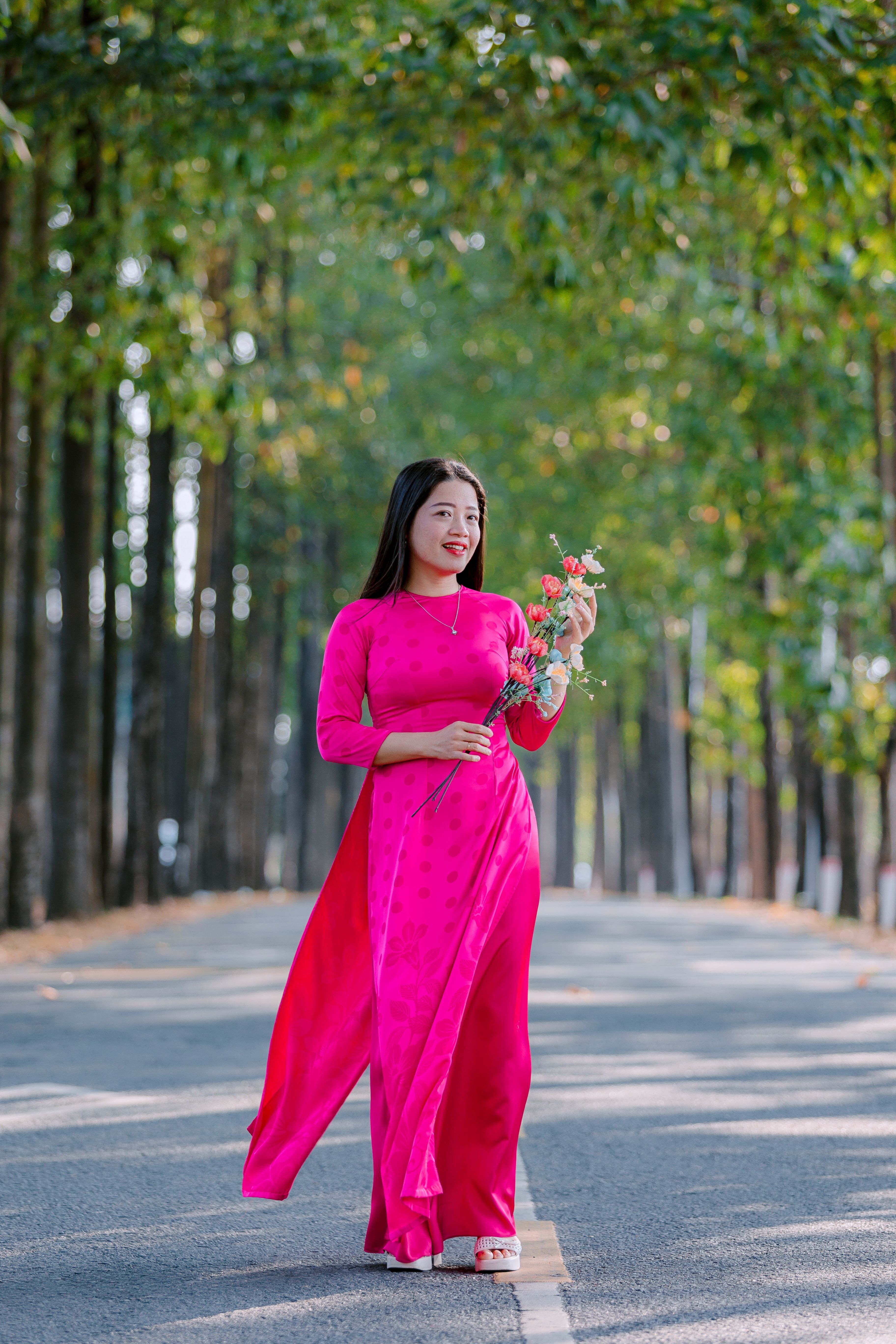 Elegant Woman in Pink Dress Walking Outdoors · Free Stock Photo
